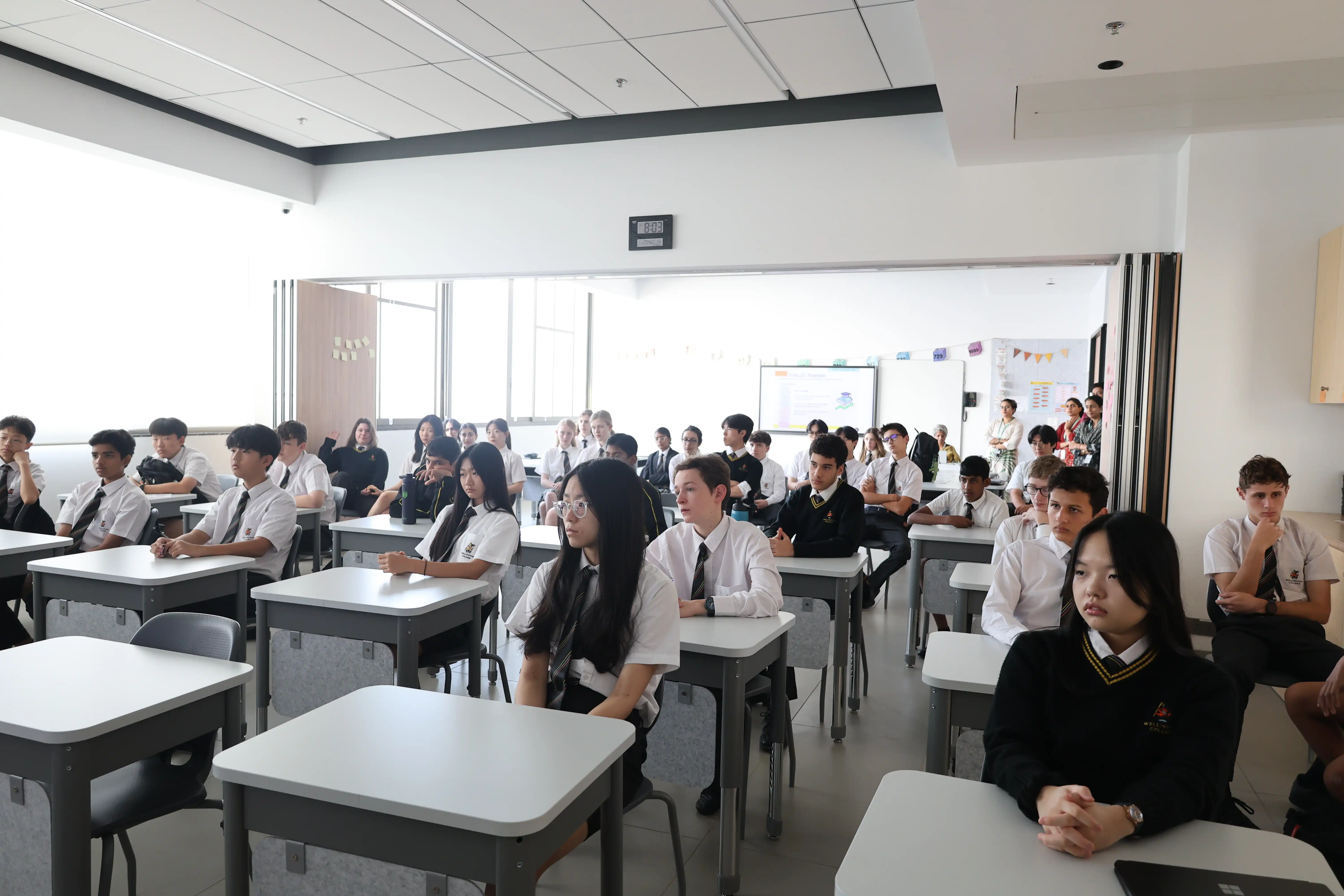 Teacher guiding senior students

